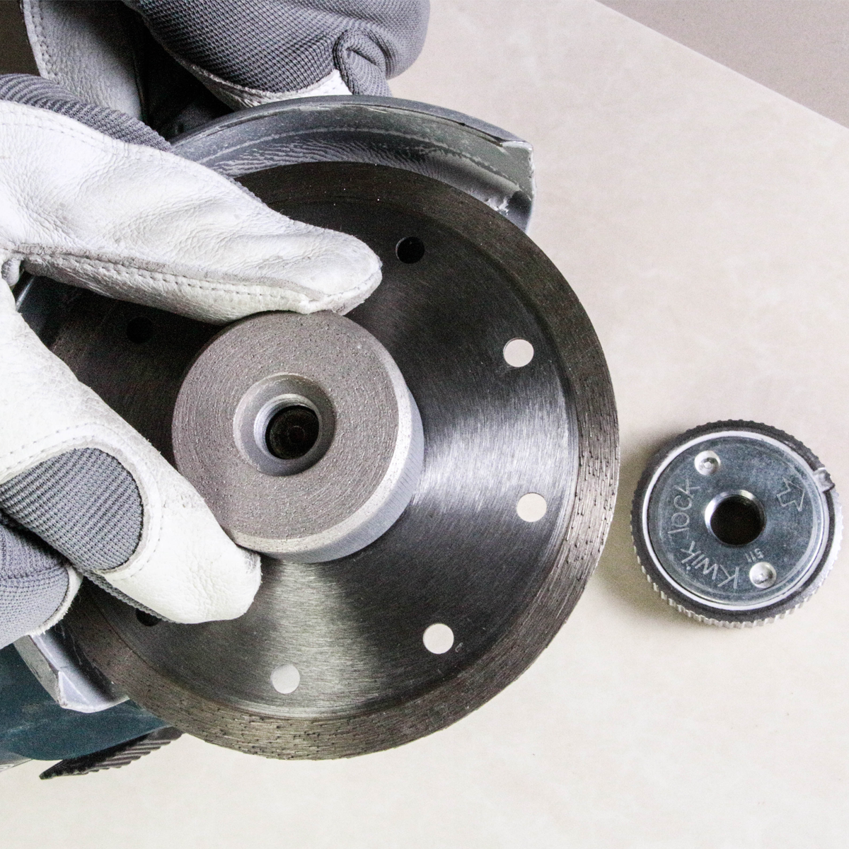 Close-up of a brake disc with gloves and another brake component on a white background