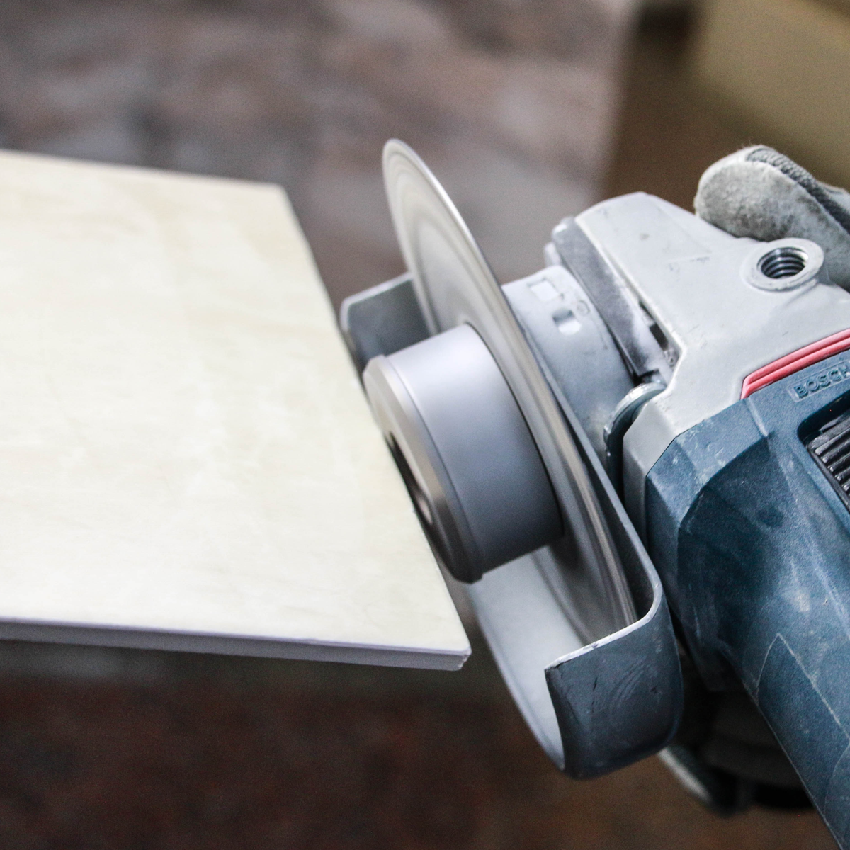 Circular saw cutting a piece of wood with a blurred background