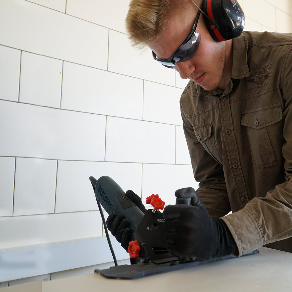 Tile installer using SLIDER 2.0 Cutting Guard on porcelain tile