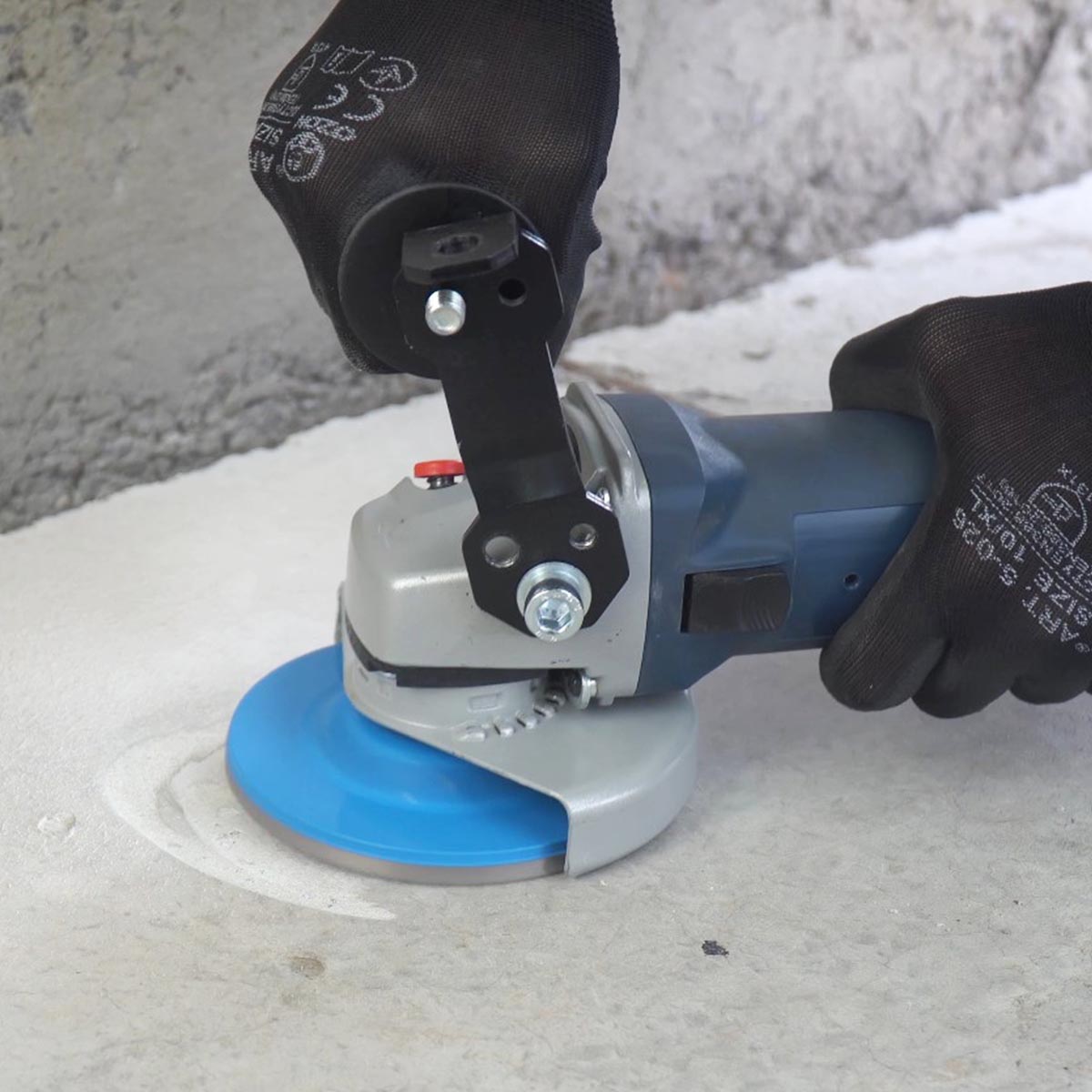 Contractor using ergonomic grinder handle for concrete grinding
